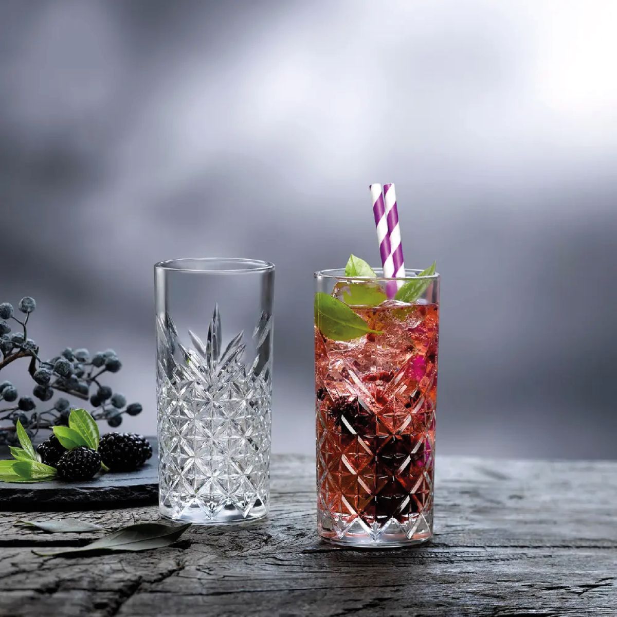 Gevuld Timeless Longdrink glas, sfeervol gepresenteerd in interieur met drank.
